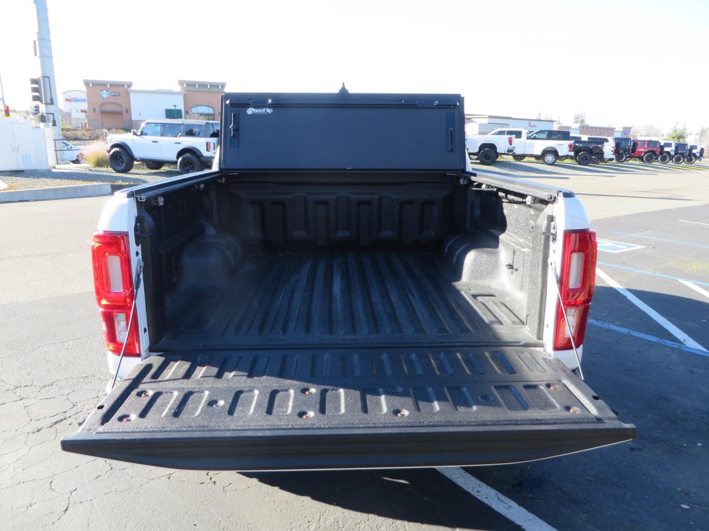 2019 White /Black Ford Ranger Lariat (1FTER4FHXKL) with an 2.3L engine, automatic transmission, located at 2630 Grass Valley Highway, Auburn, CA, 95603, (530) 508-5100, 38.937893, -121.095482 - Features a Fabtech suspension system, Fuel Offroad wheels, Nitto Ridge Grappler tires, Westin Running boards, and a Bakflip. - Photo#11